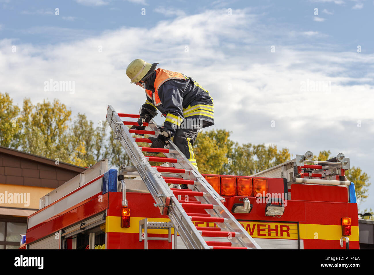 Feuerwehrmann beim abladen einer Leiter Stock Photo
