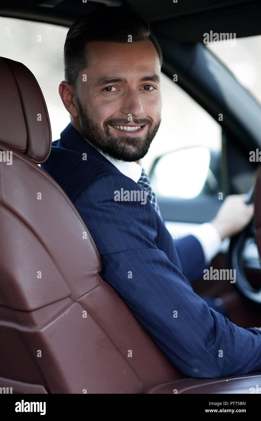 Businessman smiling behind car hi-res stock photography and images - Alamy