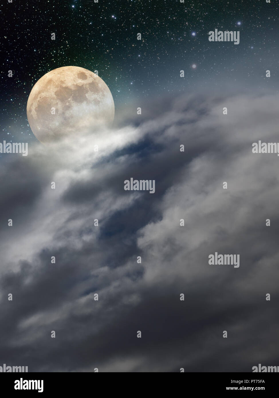 The moon rises over a region covered with clouds Stock Photo
