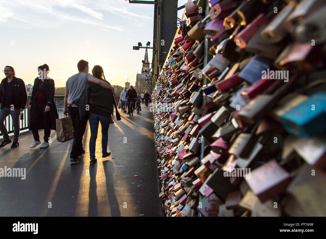 COLOGNE, GERMANY- OCTOBER 06, 2018: Tourists on the Hohenzollern Bridge. as a sign of strong love or strong friendship, loving couples or groups of co Stock Photo