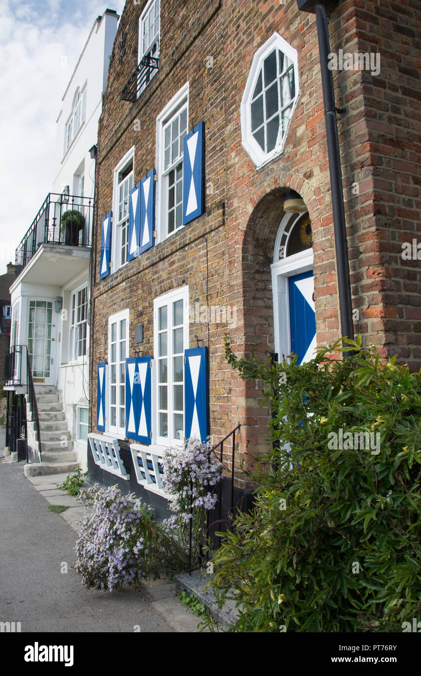 Blue and white shutters on a property on StrandOnTheGreen, Chiswick