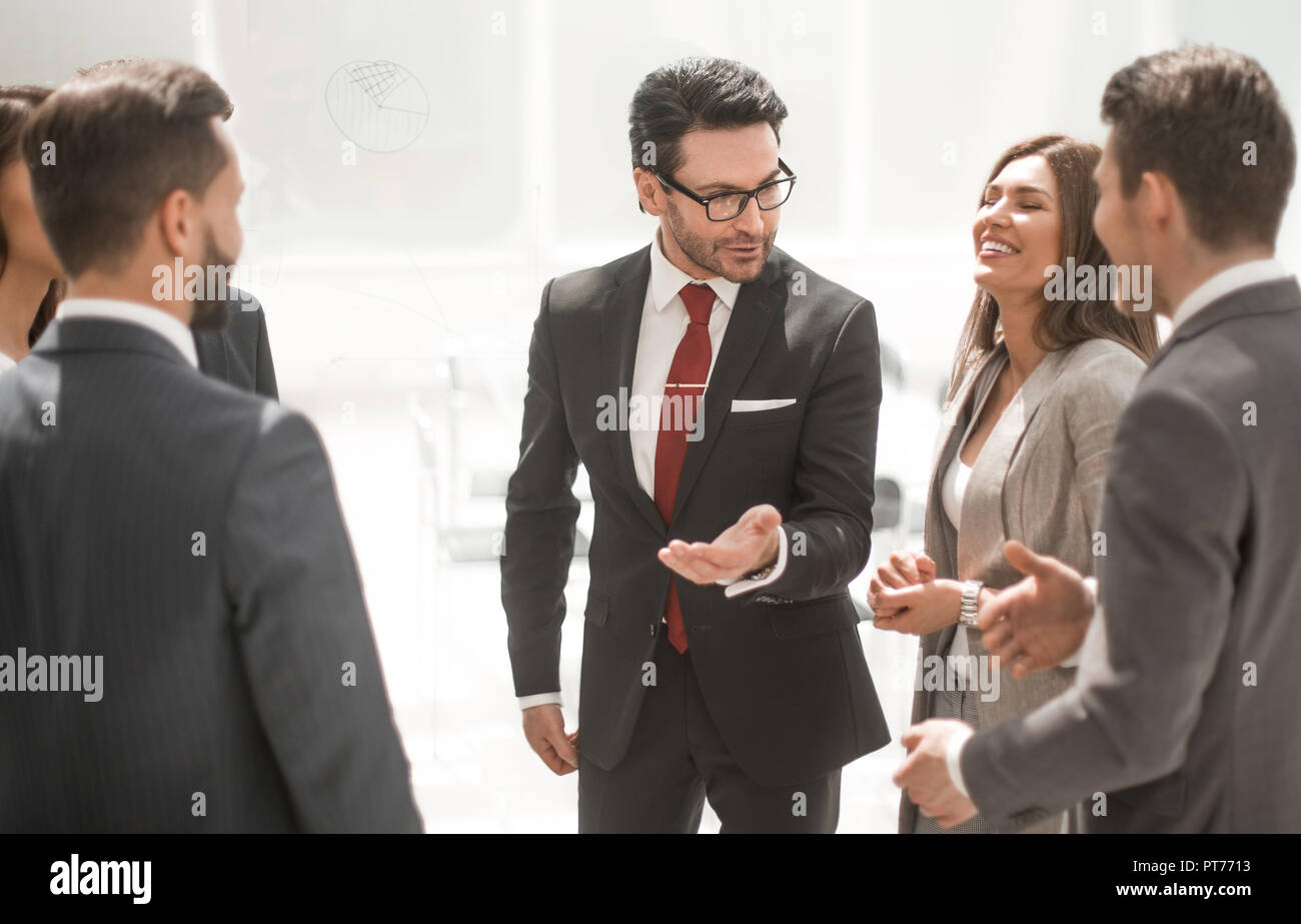 close up.a group of employees talking standing in a circle Stock Photo ...