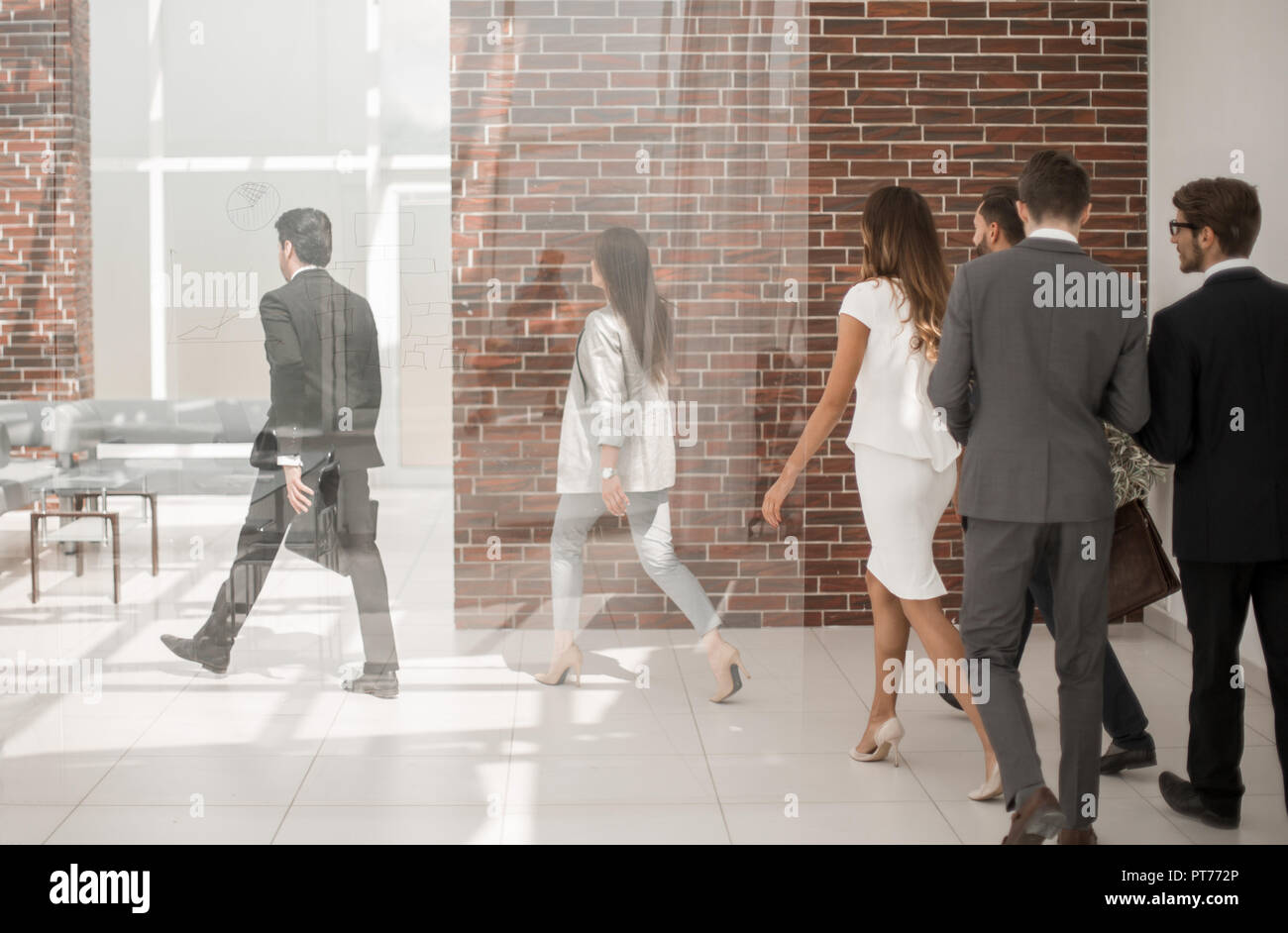 employees walking through the office hall Stock Photo - Alamy