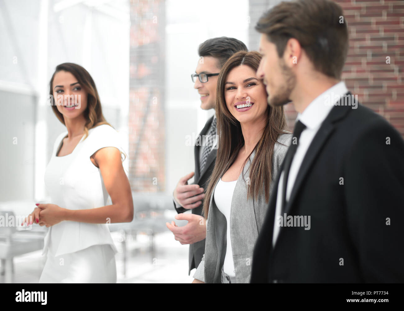business team talking standing in the office corridor Stock Photo - Alamy