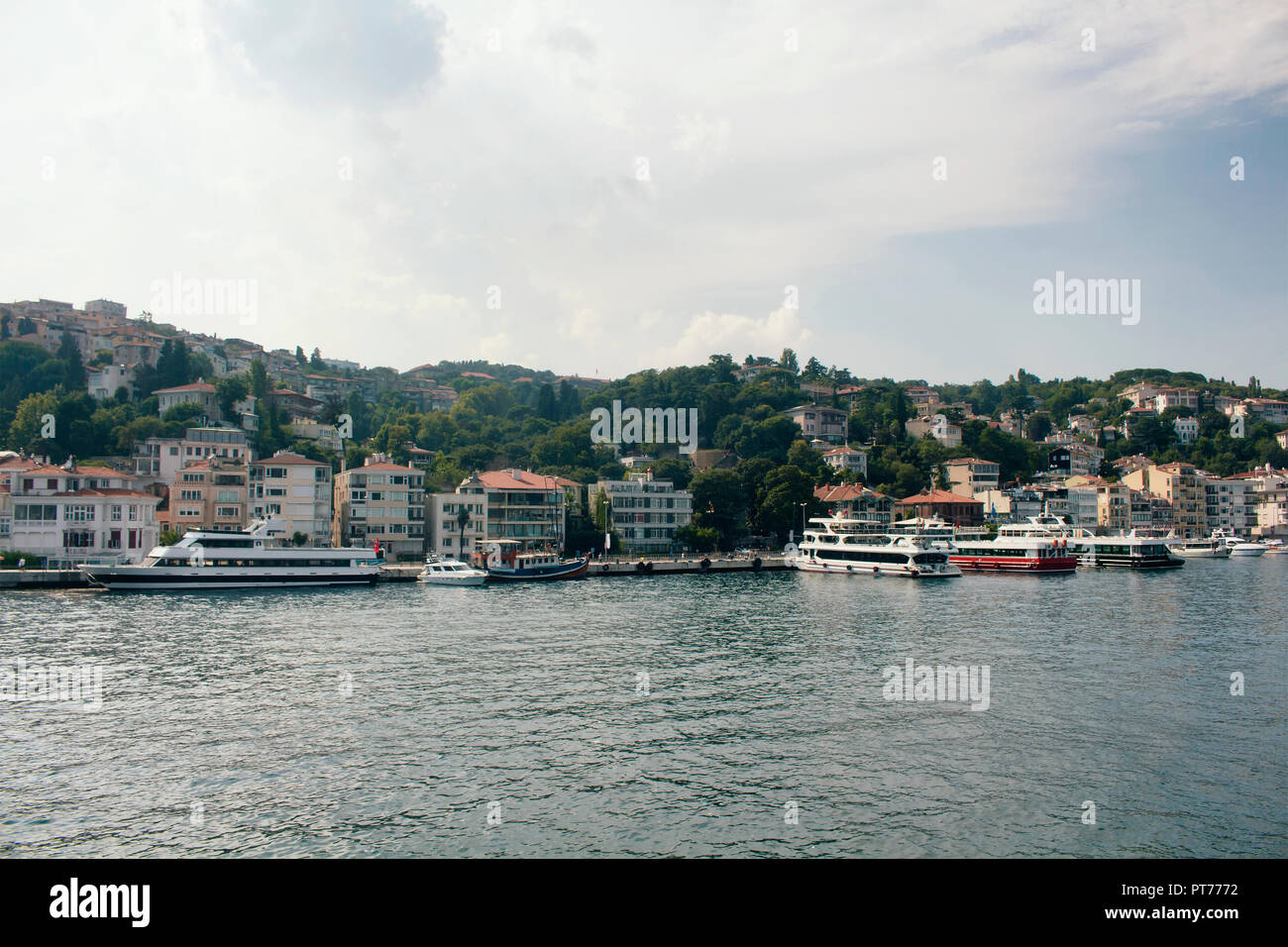 View of big motorboats, yachts, buildings on European side and Bosphorus in Istanbul. Stock Photo