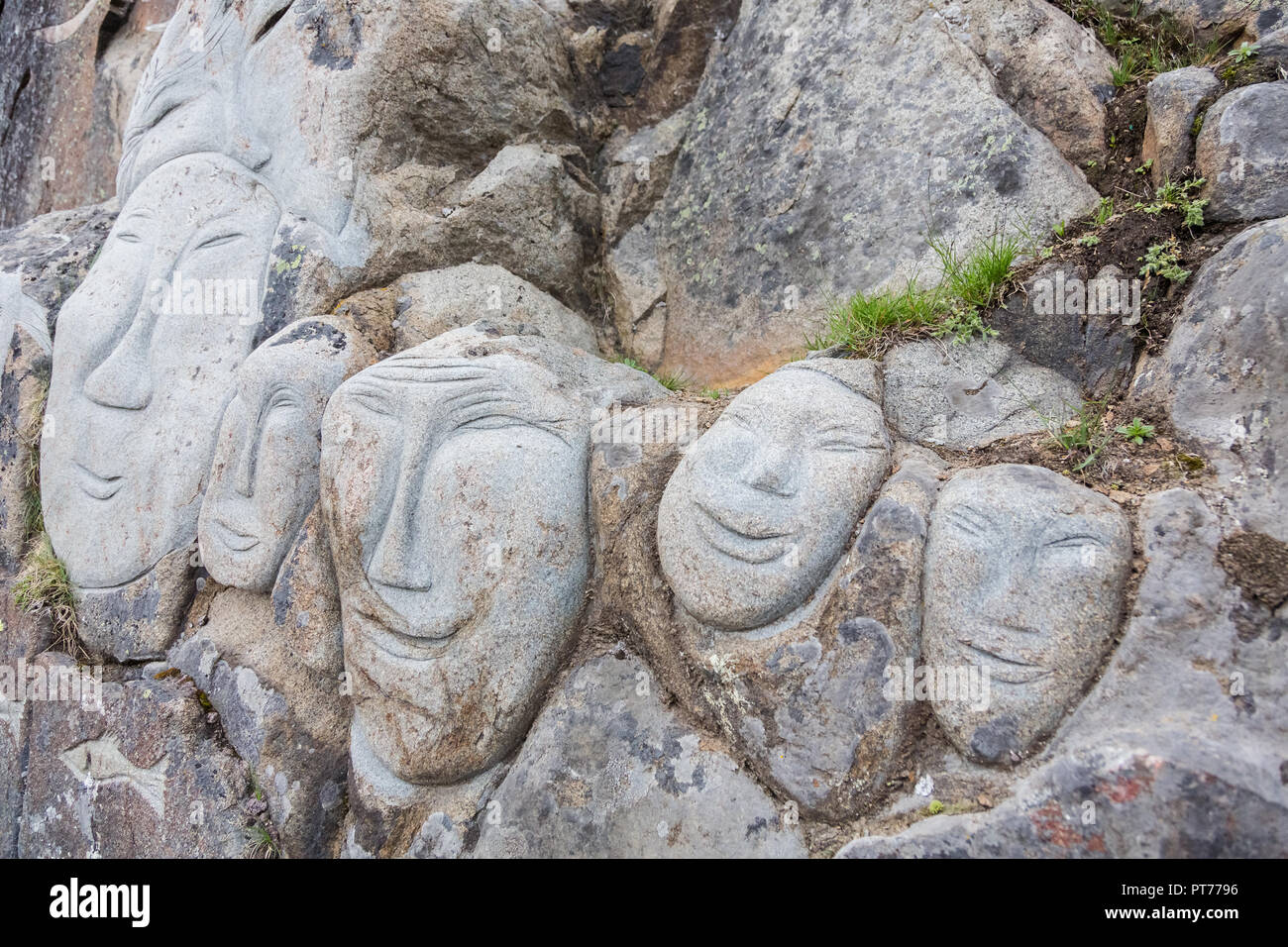 Faces on the rock face as part of the Stone & Man Sculpture, Qaqortoq