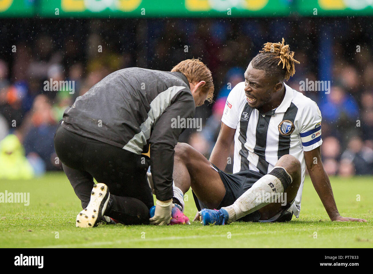 Portsmouth, UK. 6th October 2018. Gabriel Zakuani of Gillingham receives treatment during the EFL Sky Bet League 1 match between Portsmouth and Gillingham at Fratton Park, Portsmouth, England on 6 October 2018. Photo by Simon Carlton.  Editorial use only, license required for commercial use. No use in betting, games or a single club/league/player publications. Credit: UK Sports Pics Ltd/Alamy Live News Stock Photo