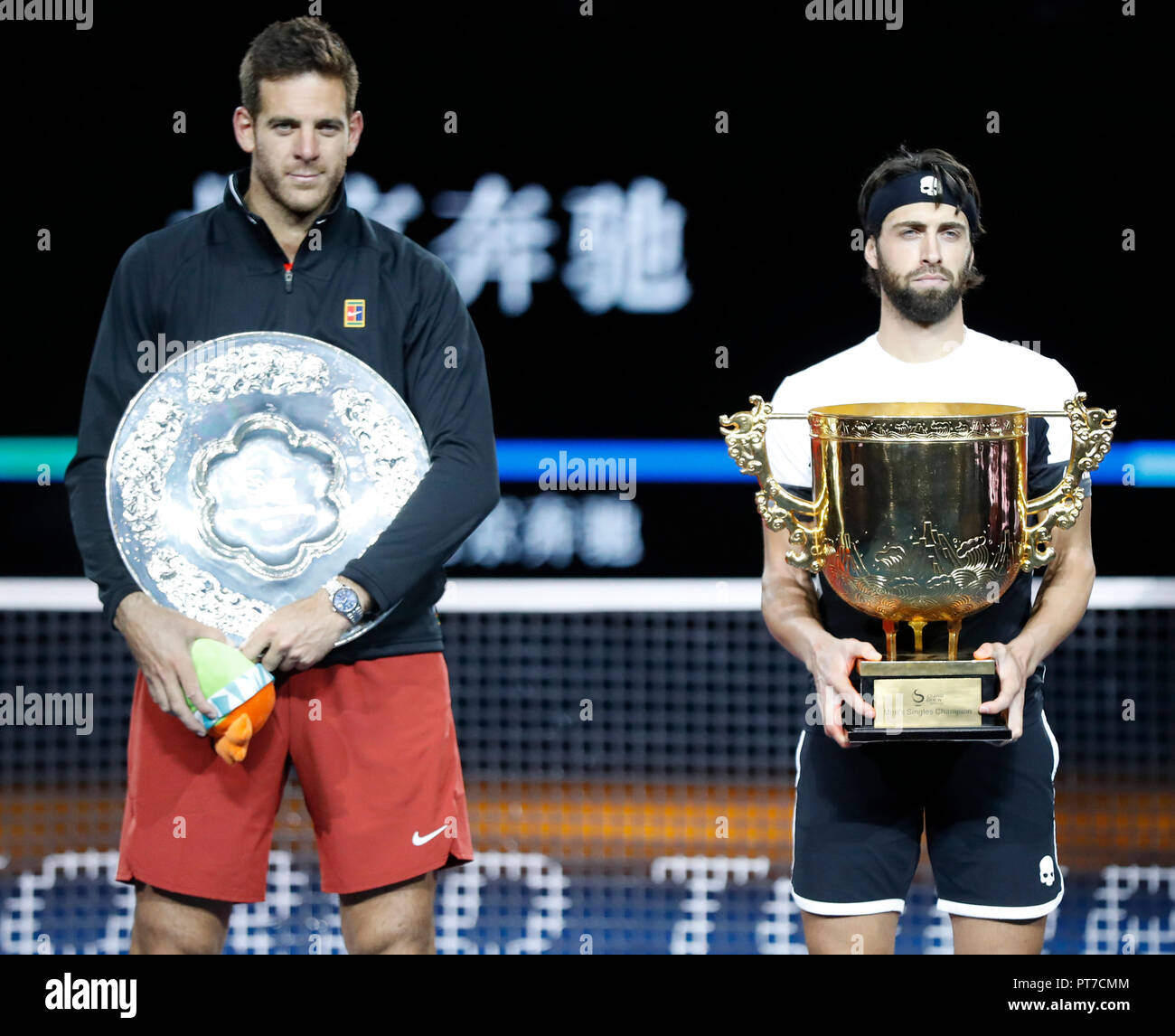 Beijing, China. 7th Oct, 2018. Winner Nikoloz Basilashvili (R) of Georgia  and runner-up Juan Martin del Potro of Argentina pose during the awarding  ceremony of the men's singles event at the China