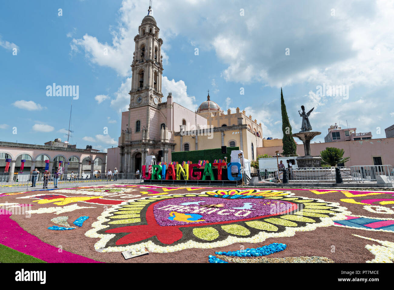 a-giant-football-field-size-floral-carpet-decorates-the-town-square-in-front-of-the-parroquia-san-miguel-archangel-church-in-the-central-mexican-town-of-uriangato-guanajuato-every-year-residents-create-giant-floral-carpets-made-from-colored-sawdust-and-decorated-with-flowers-during-the-8th-night-celebration-marking-the-end-of-the-feast-of-st-michael-uriangato-became-an-international-sensation-after-wowing-brussels-with-their-floral-carpet-displayed-at-the-brussels-grand-place-during-the-belgium-floral-carpet-festival-PT7MCE.jpg