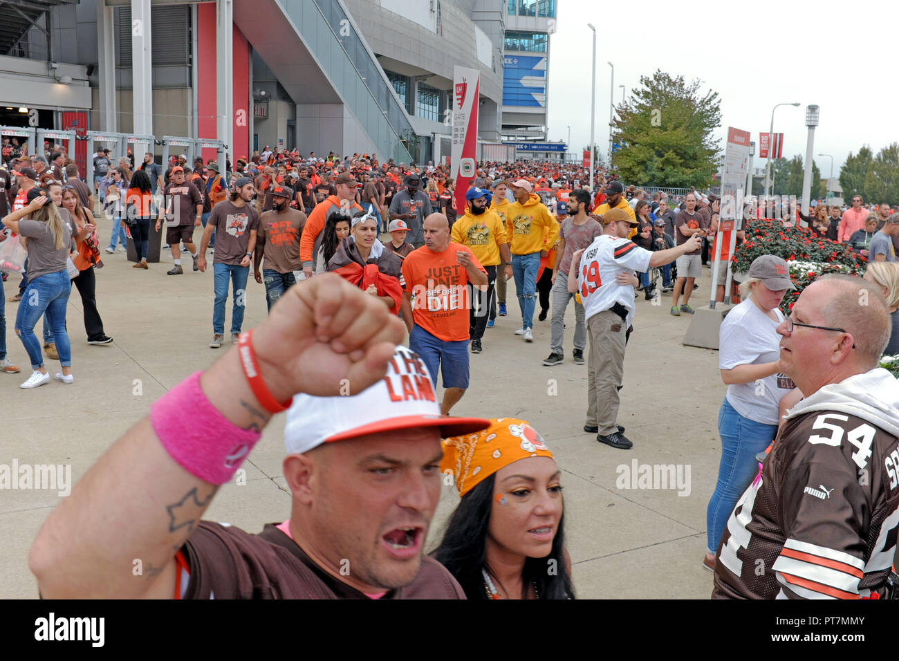 Cleveland, Ohio, USA. 7 Oct, 2018.  Cleveland Browns football fans celebrate as they leave FirstEnergy Stadium in downtown Cleveland, Ohio after beating the Baltimore Ravens 12-9 in overtime.  The win was the second for Cleveland this season.  Credit: Mark Kanning/Alamy Live News. Stock Photo