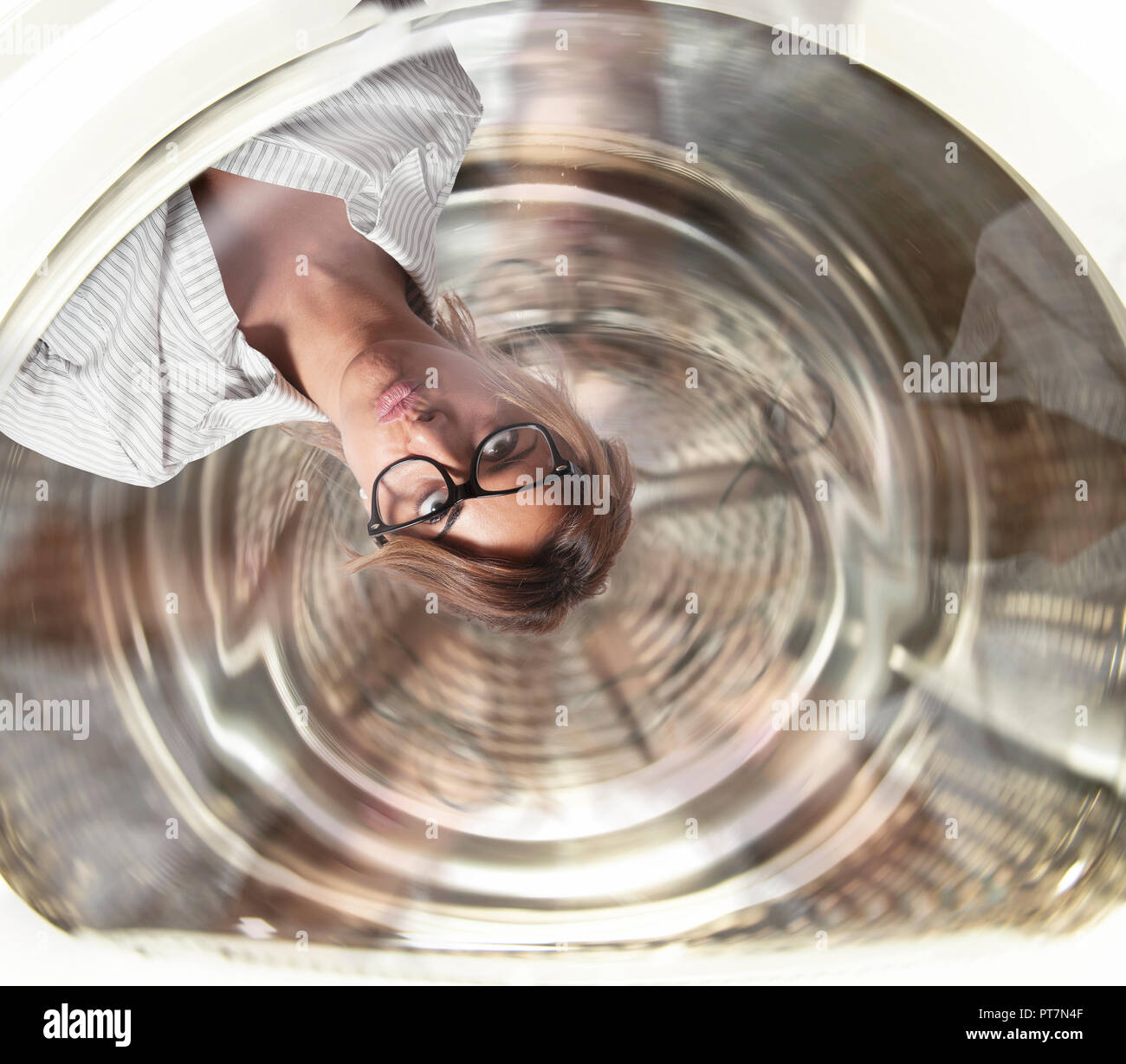 Confused businesswoman has dizziness inside a washing machine. Concept of stress and overwork Stock Photo