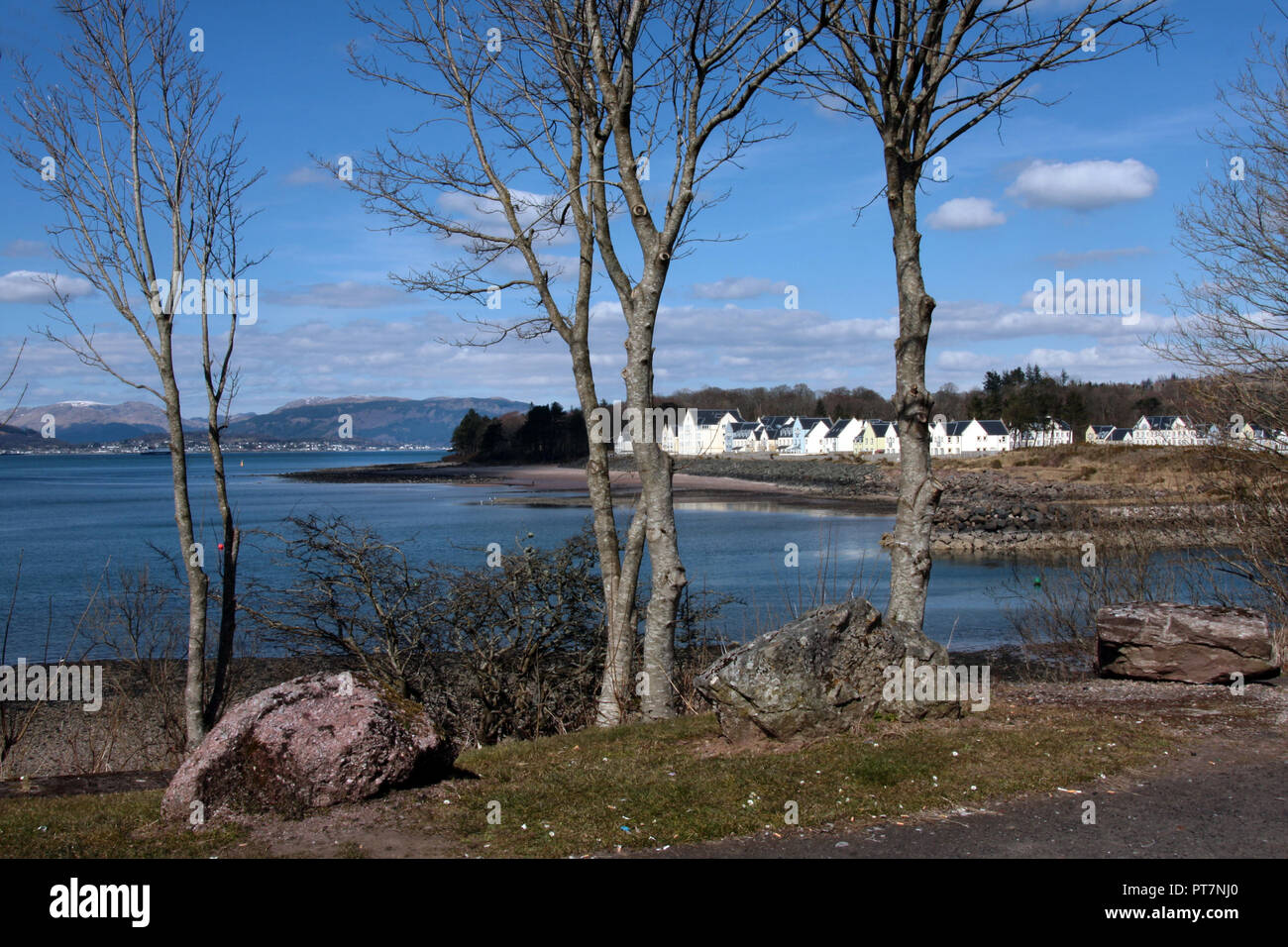 The small village of Inverkip seen here, from across the bay, with its marina on the right, is a popular haven for boating enthusiasts on the Firth of Clyde in Scotland. Stock Photo