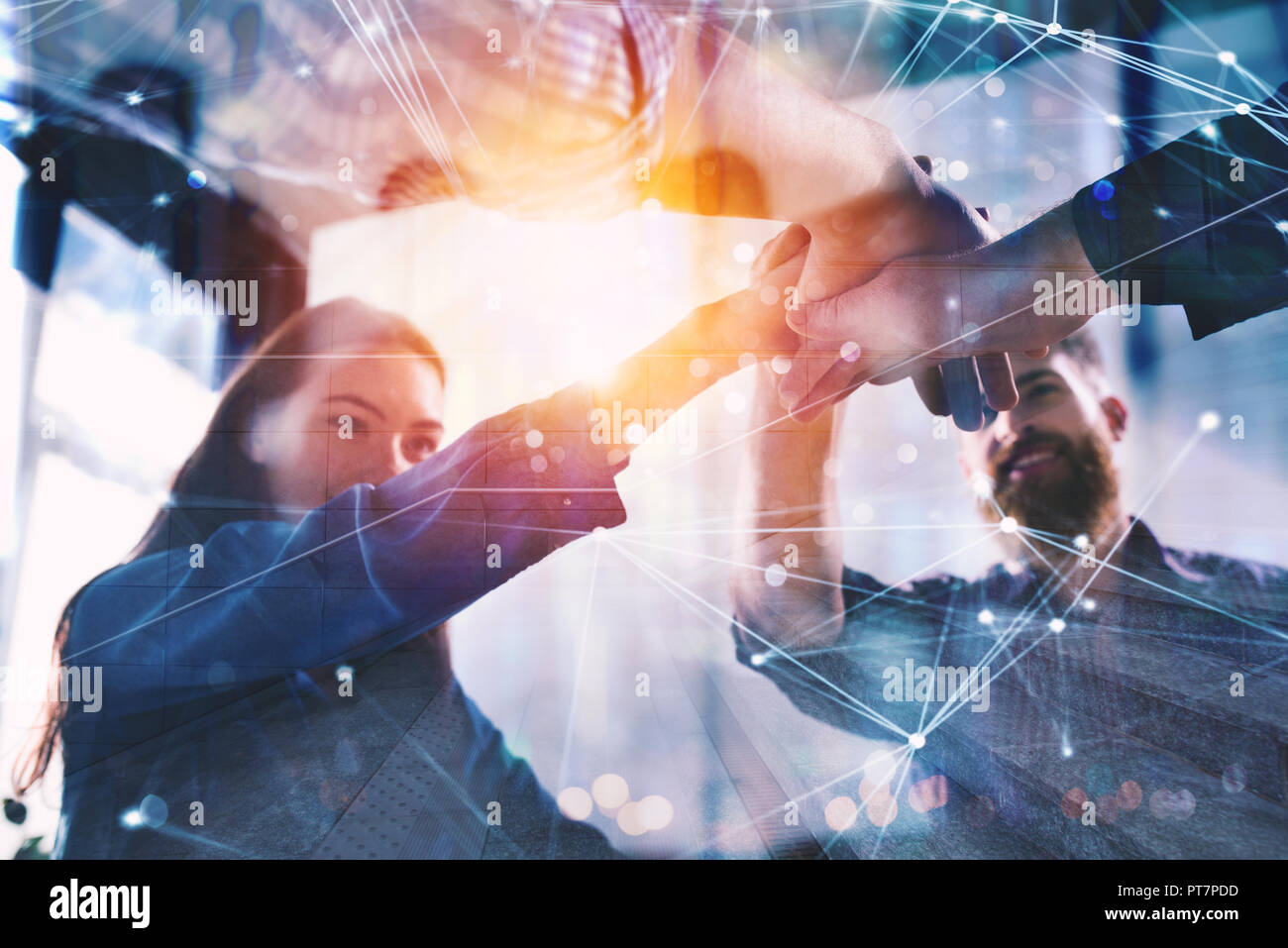 Handshaking business person in office. concept of teamwork and partnership. double exposure with light effects Stock Photo