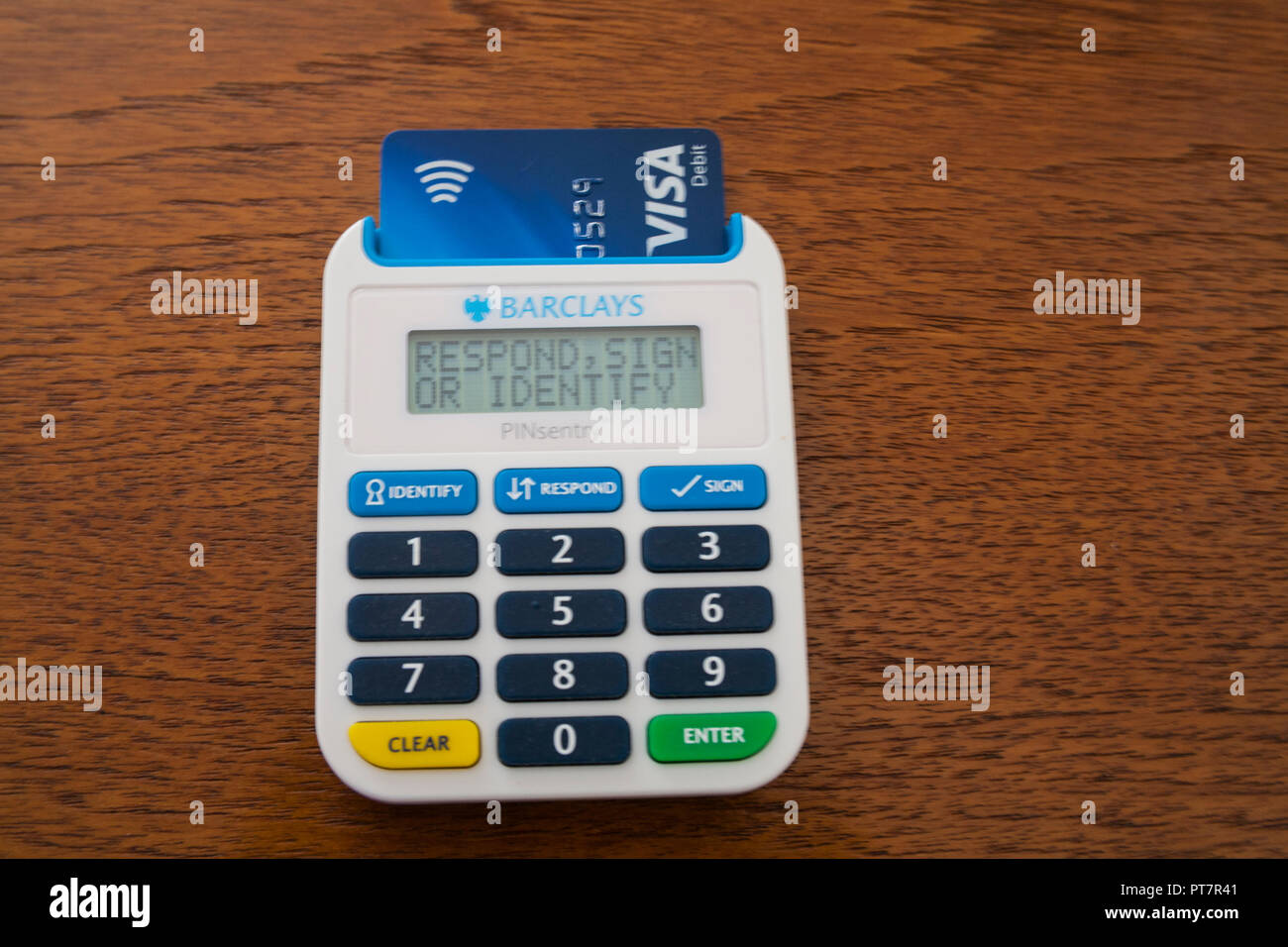 PINsentry card reader for access to Barclays Online Banking features with extra layer of security debit card inserted to access current account Stock Photo