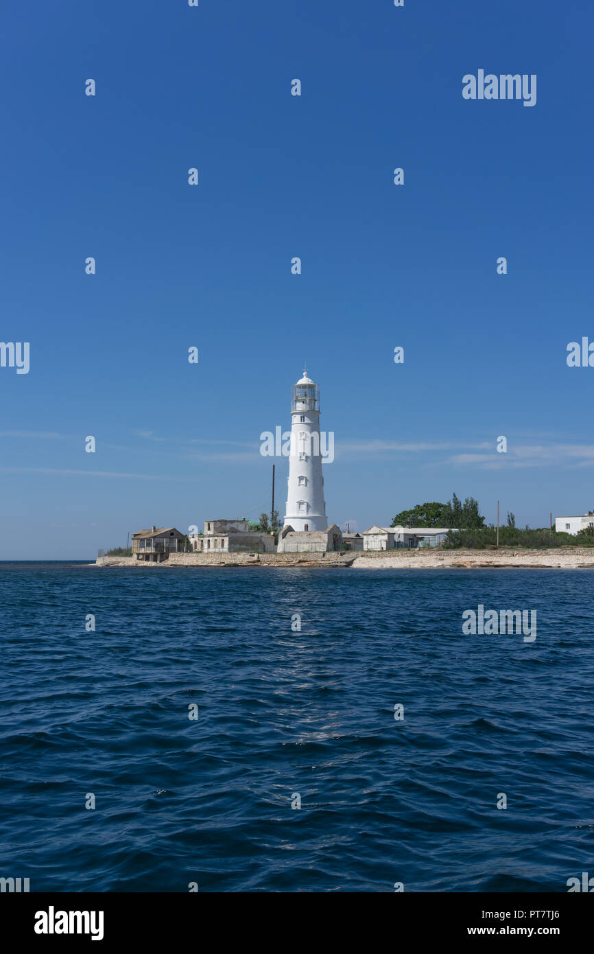 Marine landscape with views of the Cape Tarhankut and the white lighthouse against the sky. Travelling to Crimea. Stock Photo