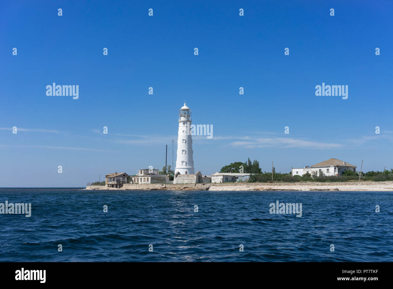 Marine landscape with views of the Cape Tarhankut and the white lighthouse against the sky. Travelling to Crimea. Stock Photo