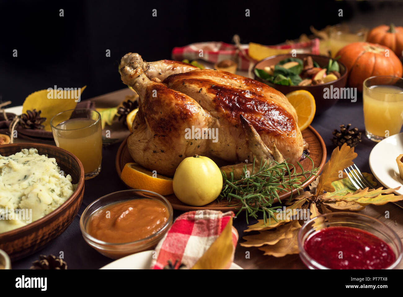 Thanksgiving Turkey Dinner with All the Sides. Homemade Roasted Turkey on Festive Thanksgiving table. Stock Photo