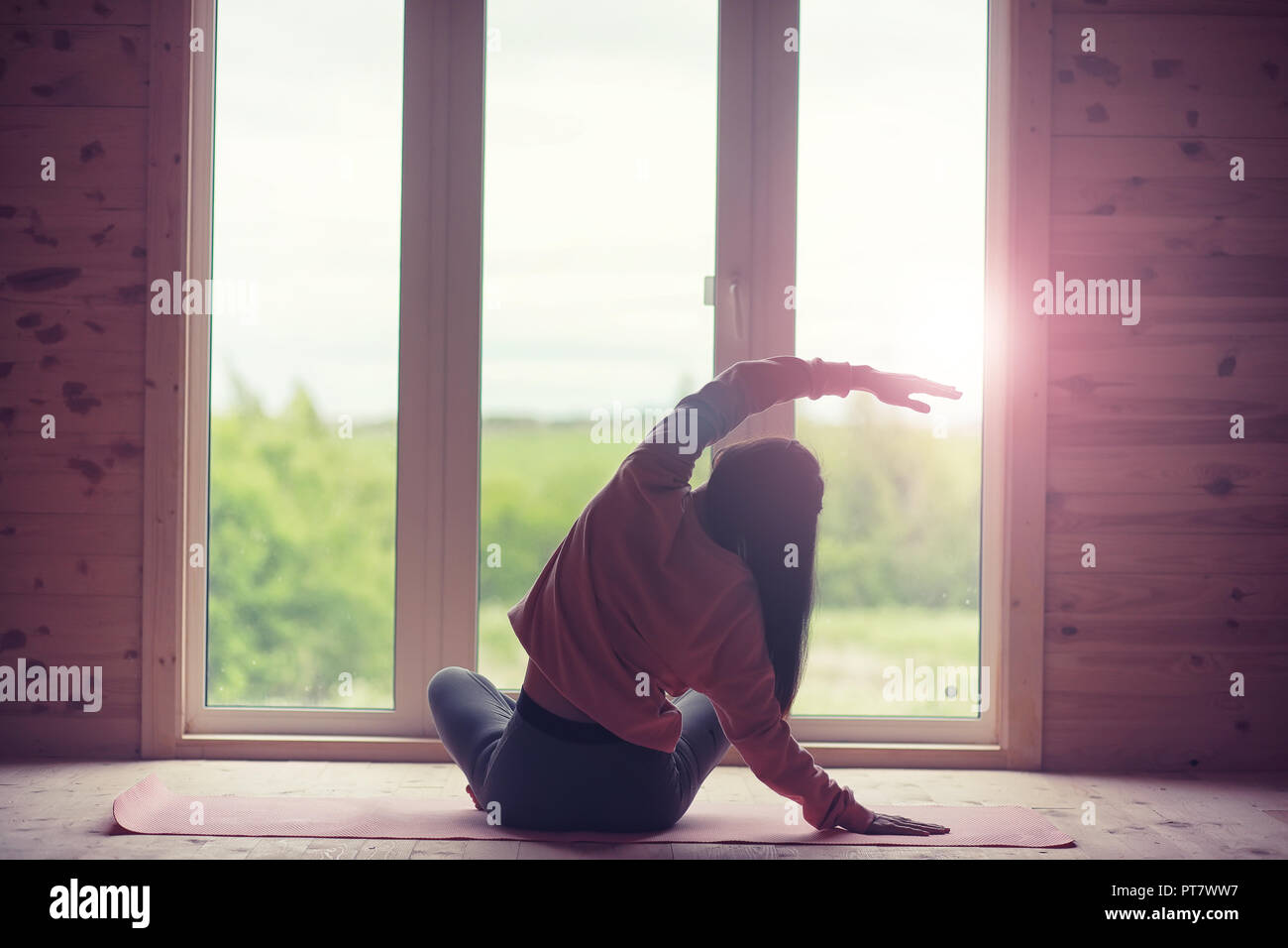 Girl in yoga poses on the floor Stock Photo - Alamy