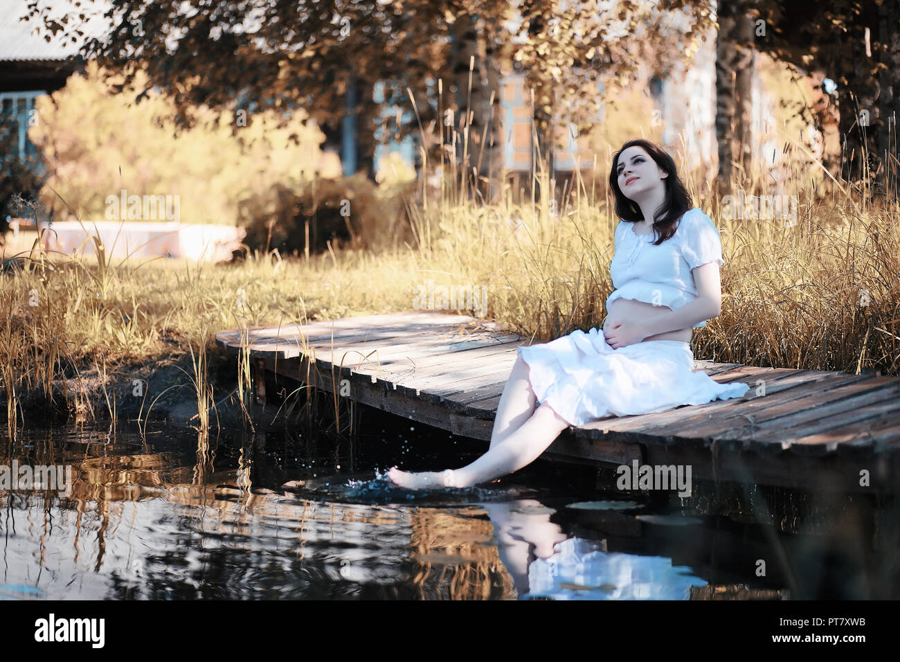 Pregnant woman in nature for a walk in the autumn Stock Photo - Alamy
