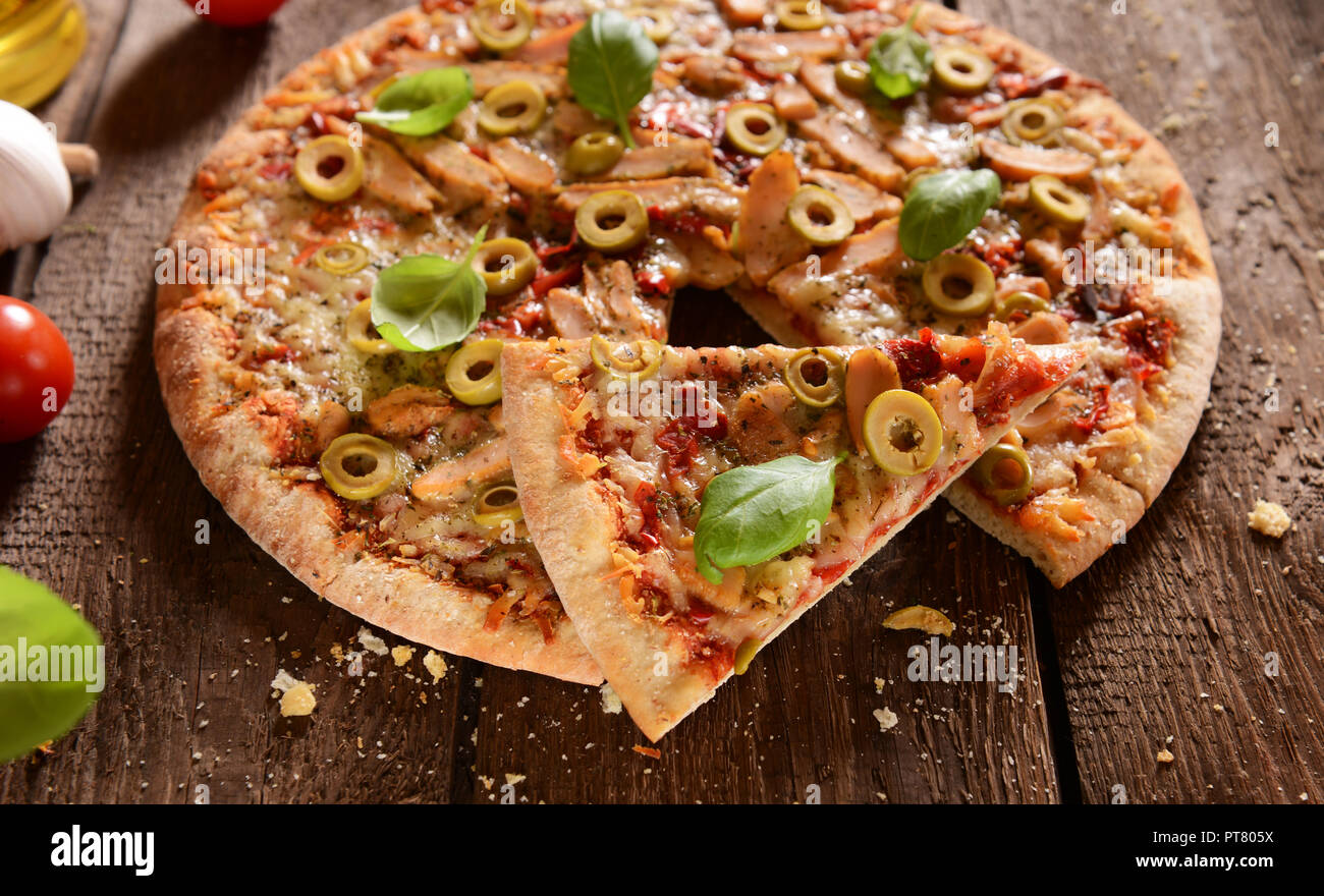 Homemade pizza with green olives, chicken and pepper Stock Photo Alamy