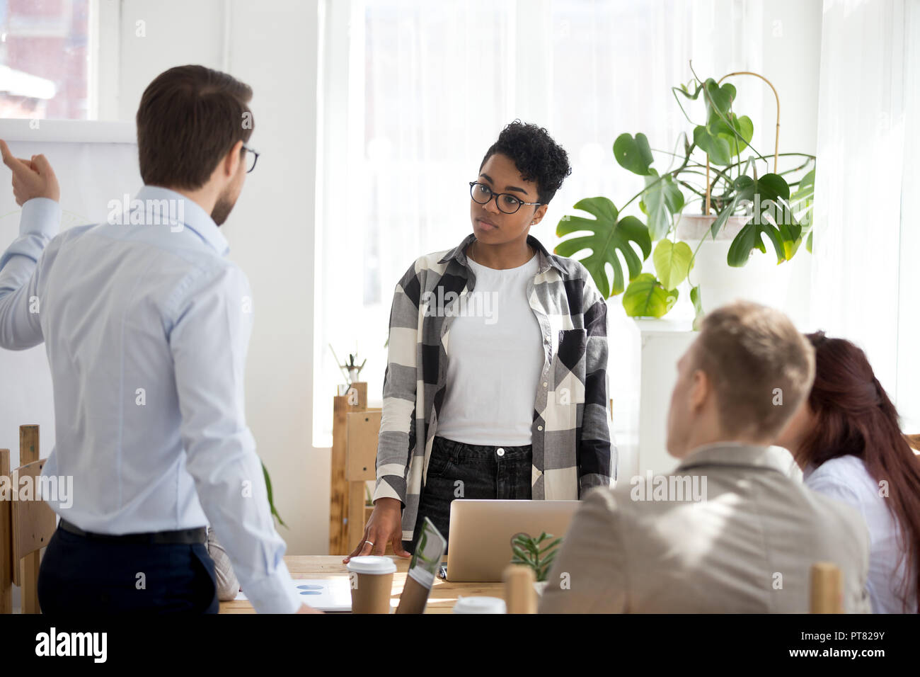 Businesspeople sitting at seminar in conference room indoors Stock Photo
