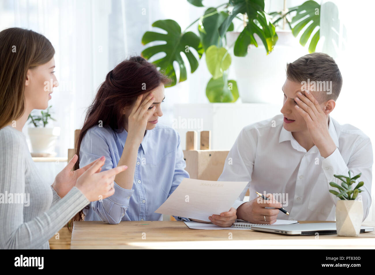 Employers and candidate sitting in office during interview Stock Photo