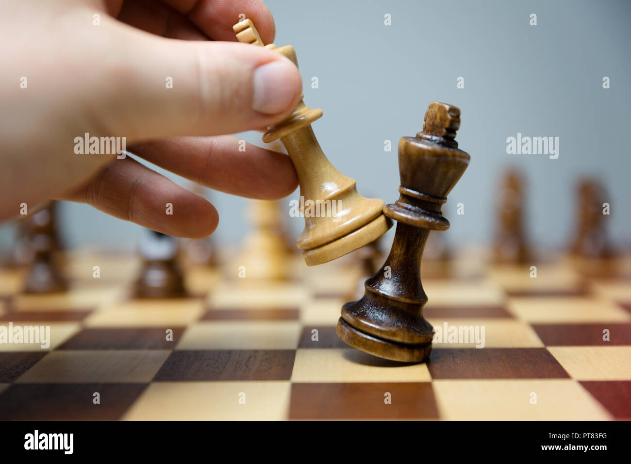hand of businessman moving chess figure in competition success play. strategy, management or leadership concept Stock Photo