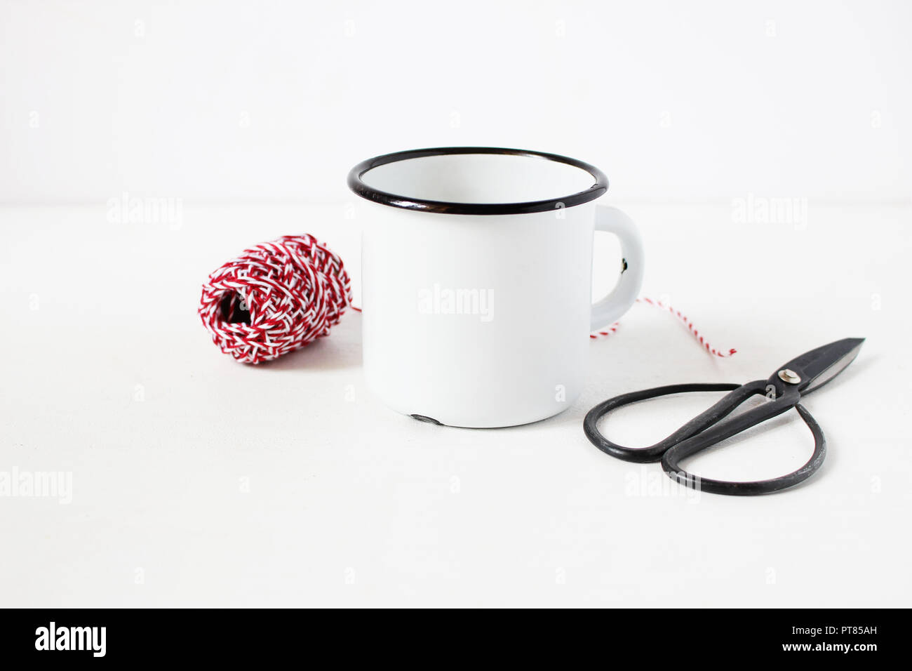 Download Winter Still Life Composition With Blank White Metal Coffee Mug Vitage Scissors And Red Decorative Gift Rope On White Table Background Christmas Styled Stock Photo Rustic Scene Product Mockup Stock Photo