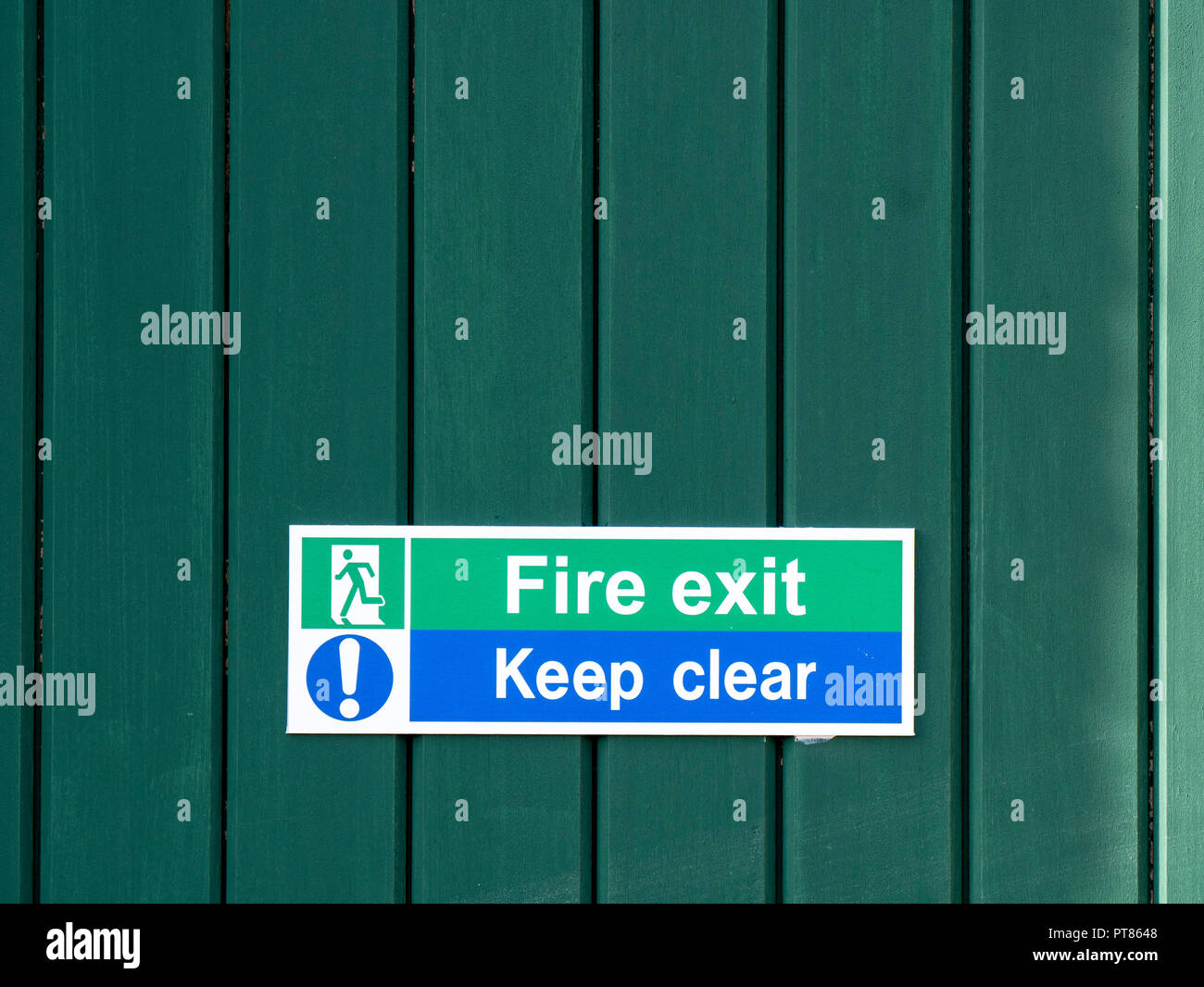 Sign on green door stating Fire Exit Keep Clear Stock Photo