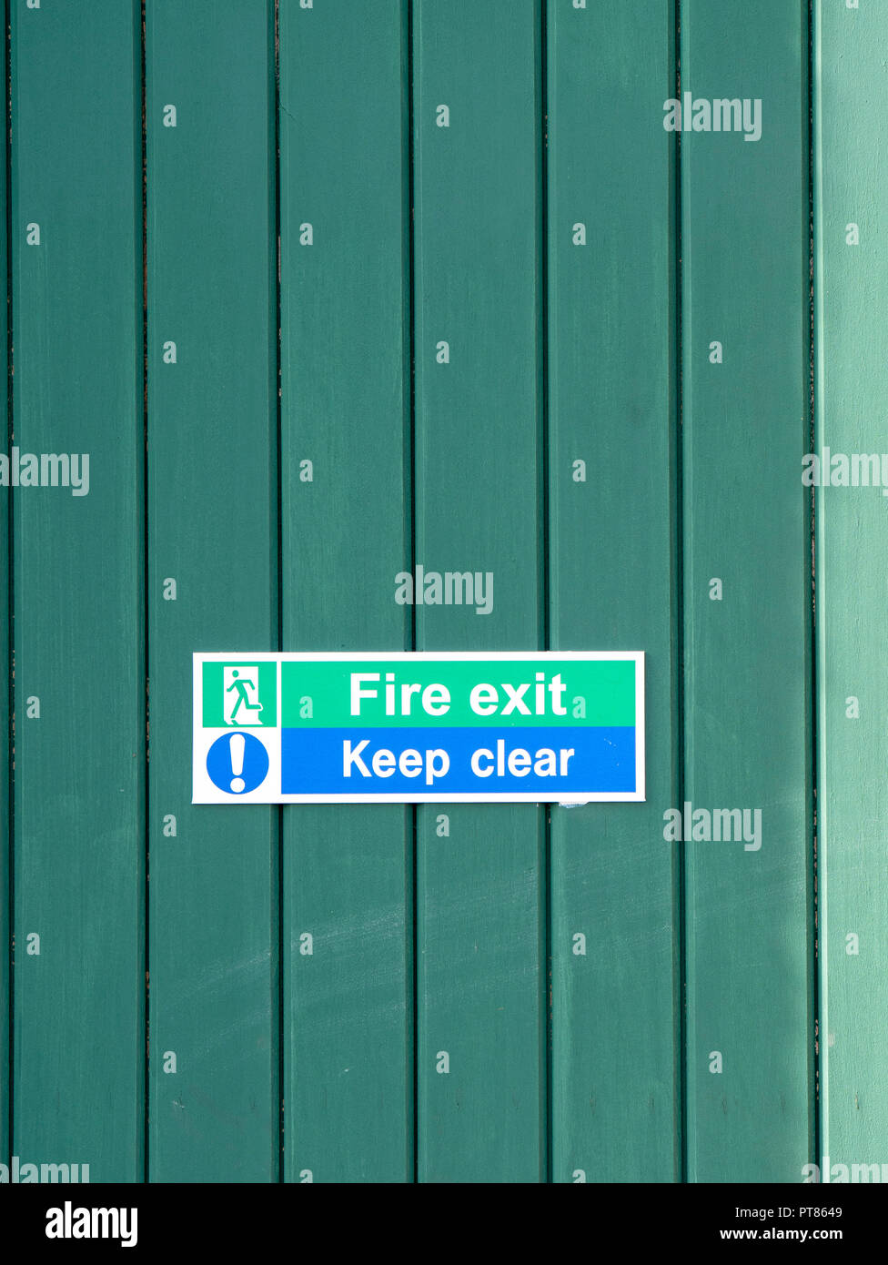 Sign on green door stating Fire Exit Keep Clear Stock Photo