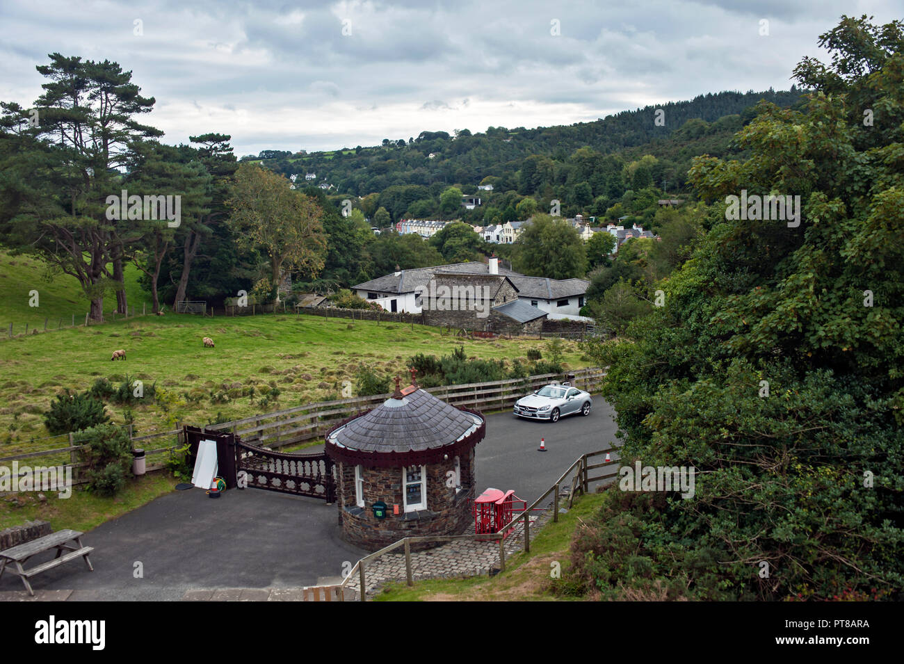 Entrance hut, The Laxey Wheel, Laxey, Isle of Man with Laxey village in background. Stock Photo