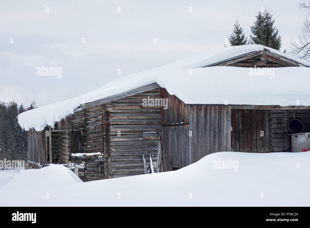 wooden hut covered in snow Stock Photo