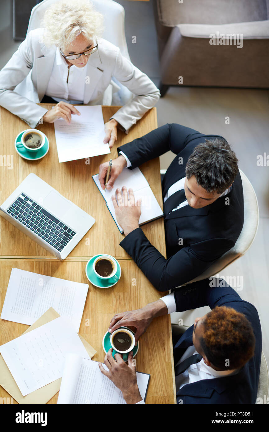 Mature businessman attentively discussing project hi-res stock ...