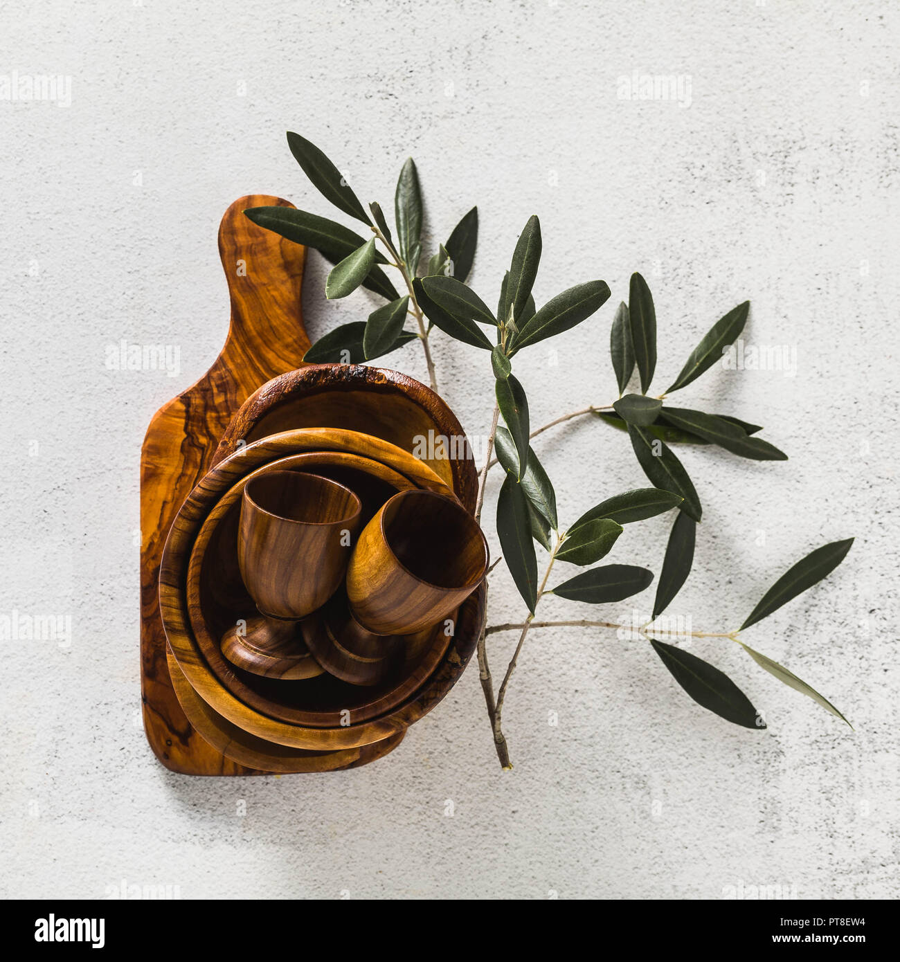 wooden utensils from the olive tree on the white kitchen table and the