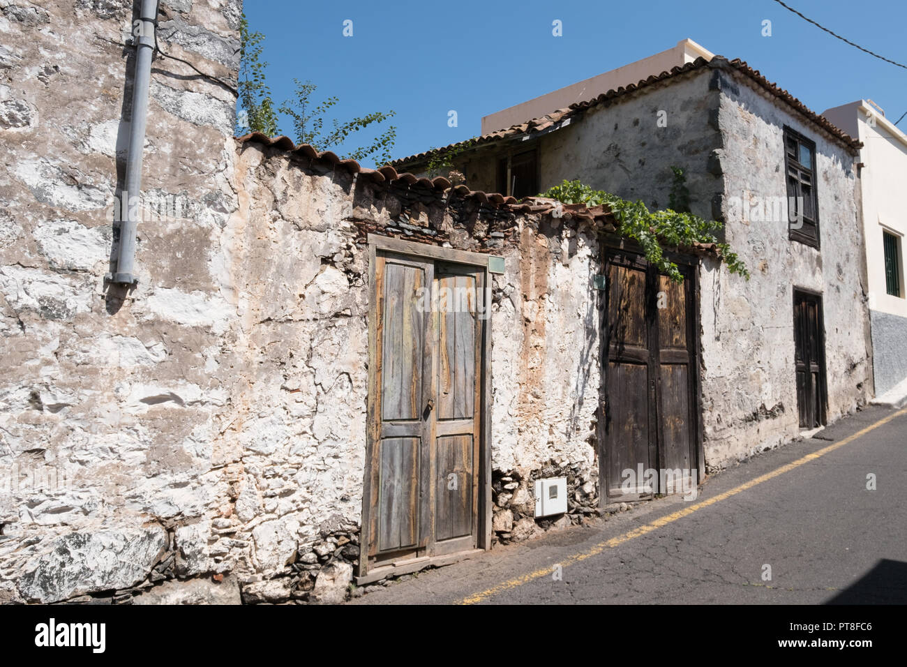 old house with wooden door and weathered facade in rural village Stock ...