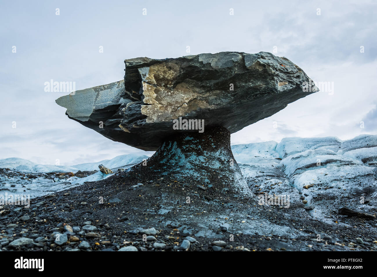 As the sun melts glacier ice, large boulders protect the ice under them