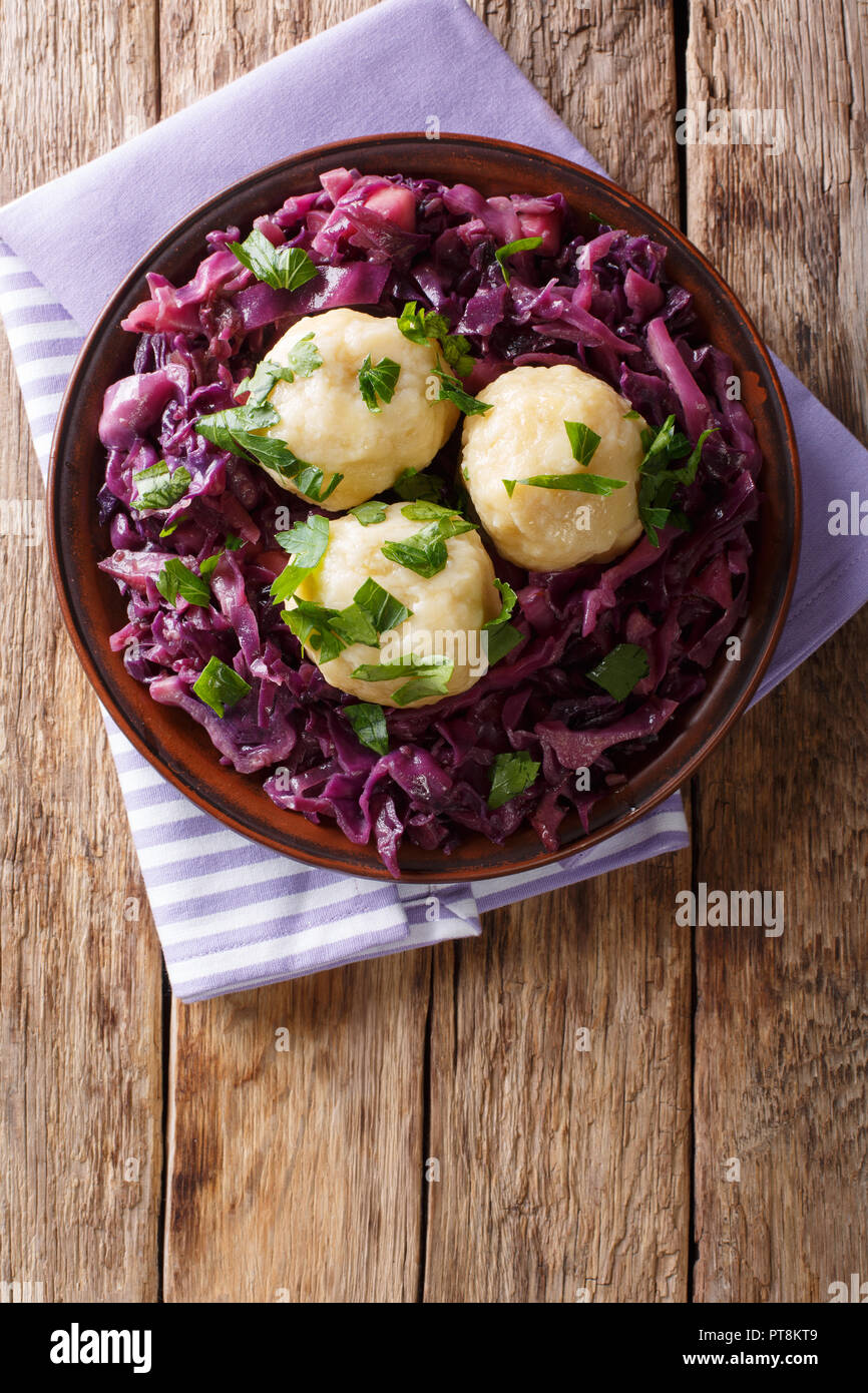 German food knodel potato dumplings and stewed red cabbage closeup on