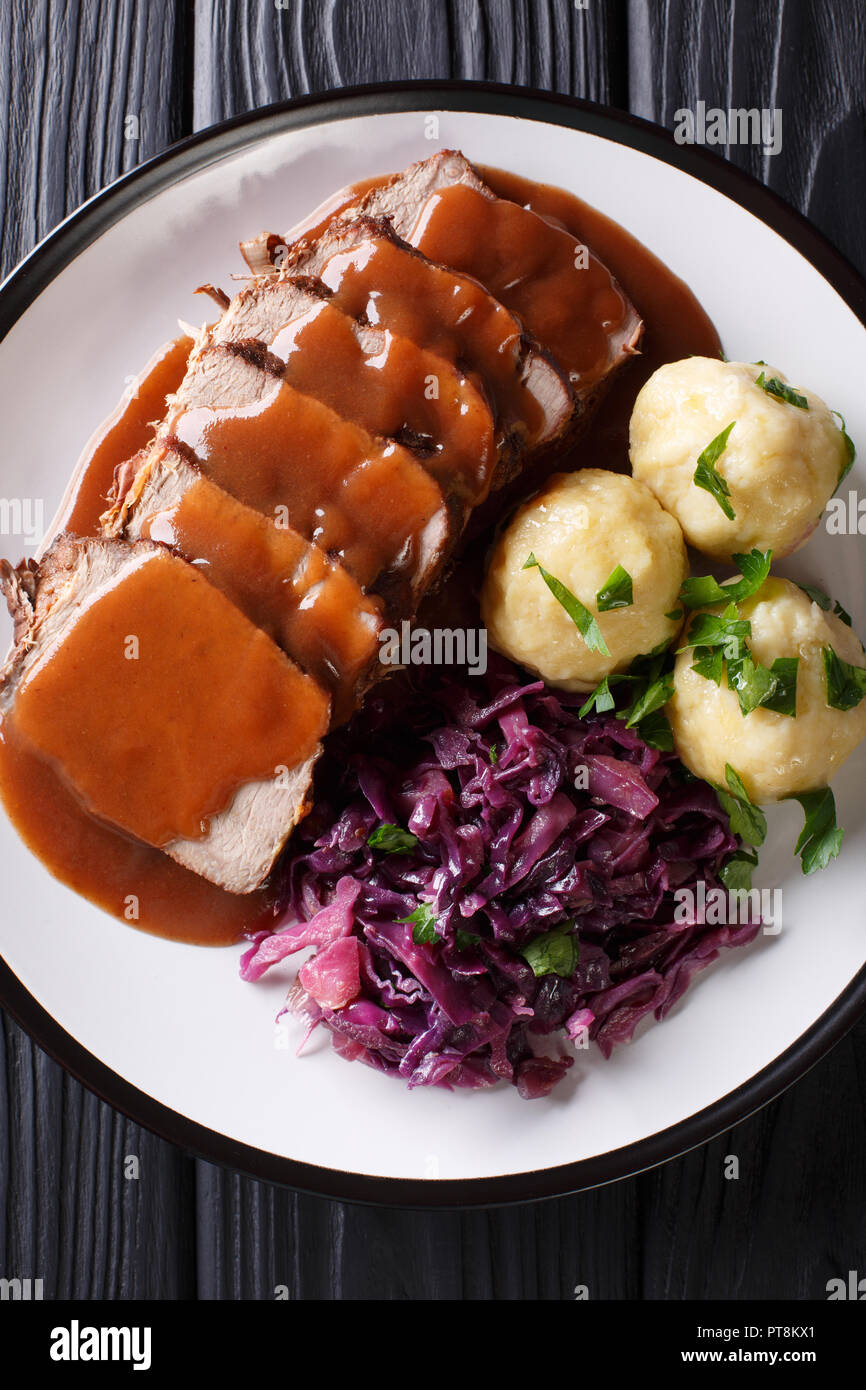 german-roast-pot-sauerbraten-served-with-potato-dumplings-and-red-cabbage-close-up-on-a-plate-vertical-top-view-from-above-PT8KX1.jpg