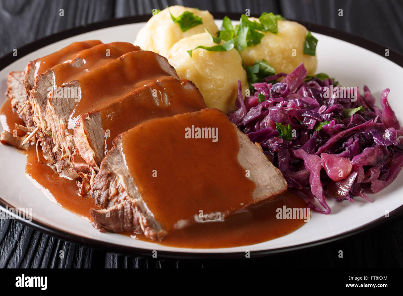 German sauerbraten on a plate with dumplings hires stock photography