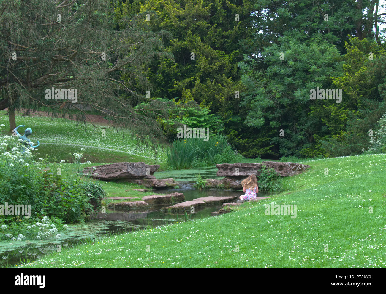 Little girl playing in a country garden Stock Photo