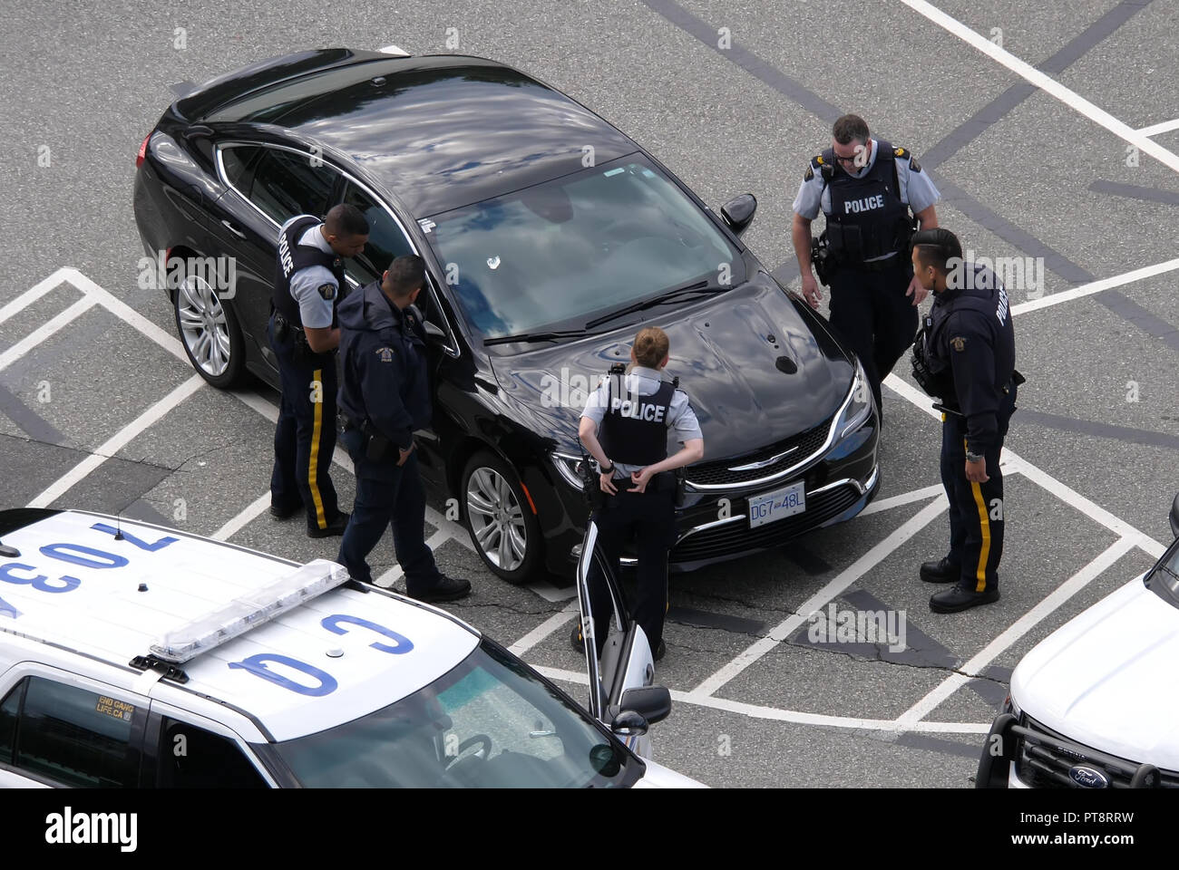 Coquitlam, BC, Canada - July 07, 2018 : Motion of police catching a stolen car at parking lot in Coquitlam BC Canada Stock Photo