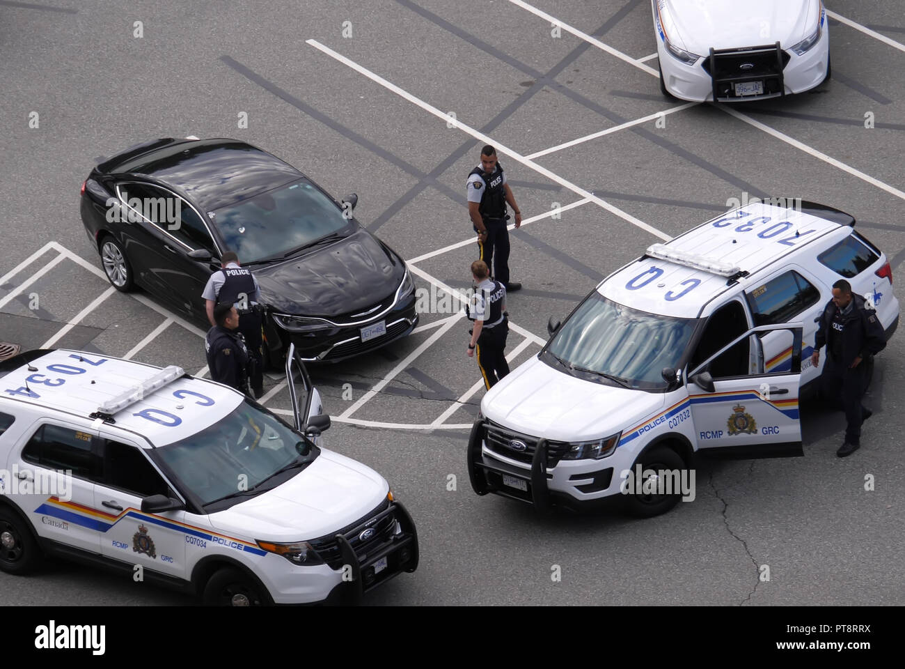 Coquitlam, BC, Canada - July 07, 2018 : Motion of police catching a stolen car at parking lot in Coquitlam BC Canada Stock Photo