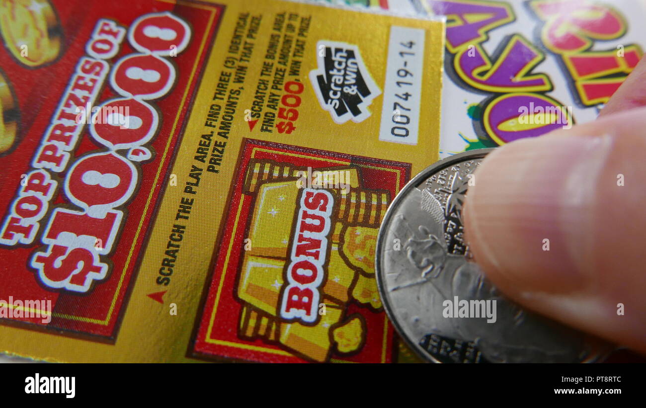 Coquitlam BC Canada - October 05, 2018 : Woman scratching lottery ticket on bonus section. The British Columbia Lottery Corporation has provided gover Stock Photo