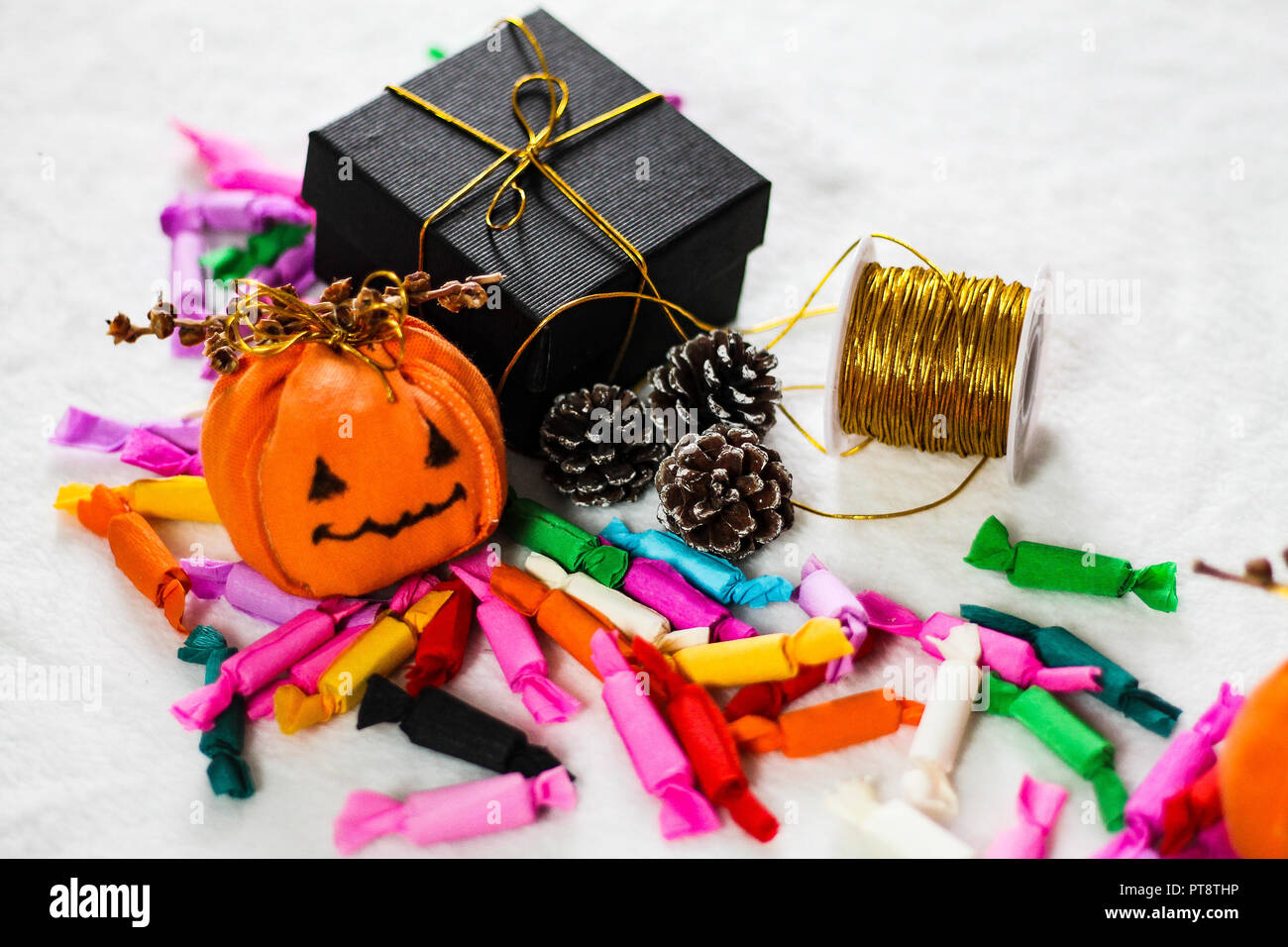 Simple handmade jack o lantern decorations and colorful candy for trick or treat during halloween Stock Photo