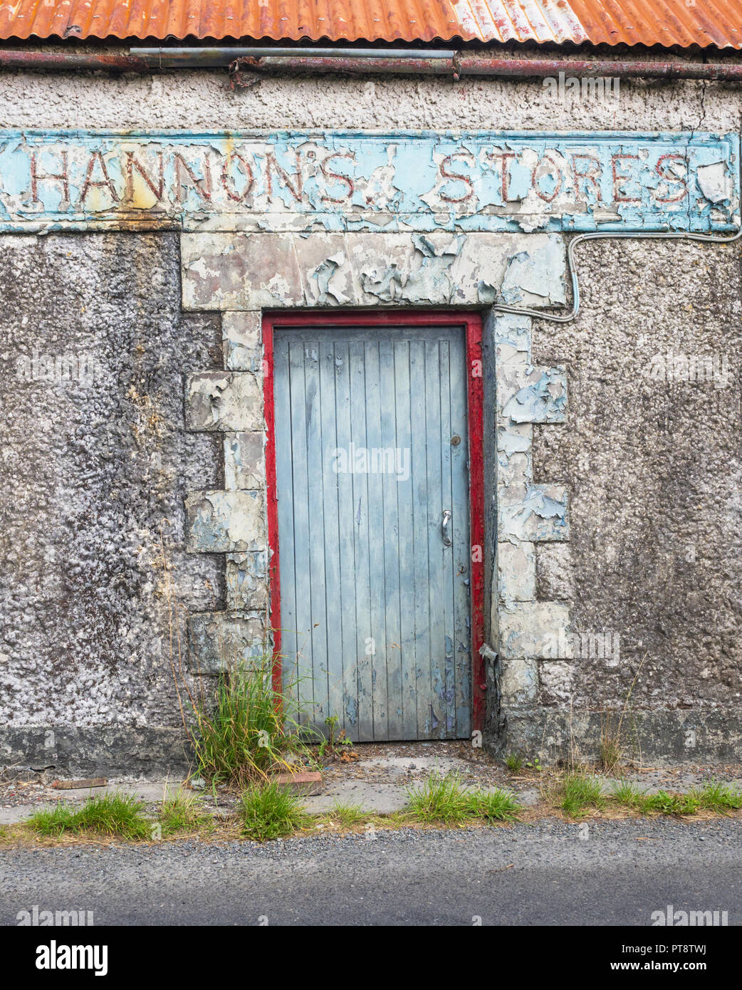 HEADFORD, IRELAND - AUGUST 8, 2018: The abandoned Hannon's Stores building next to a country road near Headford, in County Galway, Ireland. Stock Photo