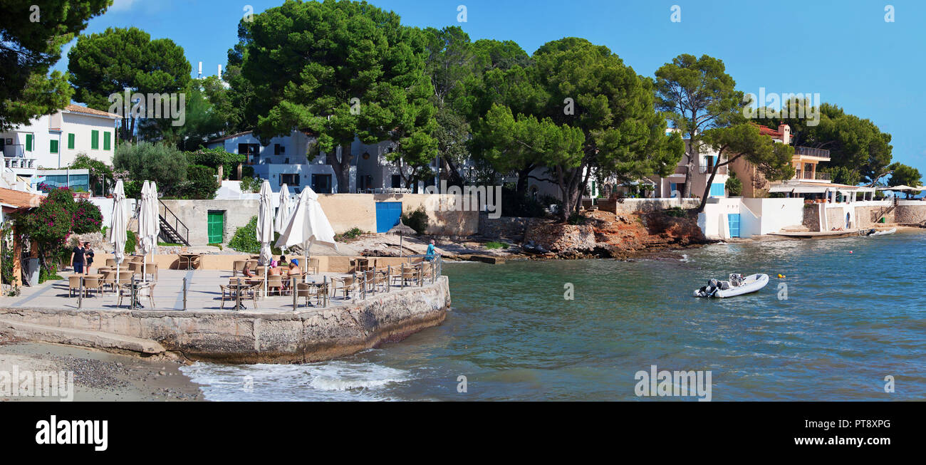 ALCUDIA, MAJORCA, SPAIN - September 26th, 2018: People enjoy sunny afternoon on the terrace of a restaurant on Cala Poncet beach near Port d'Alcudia. Stock Photo