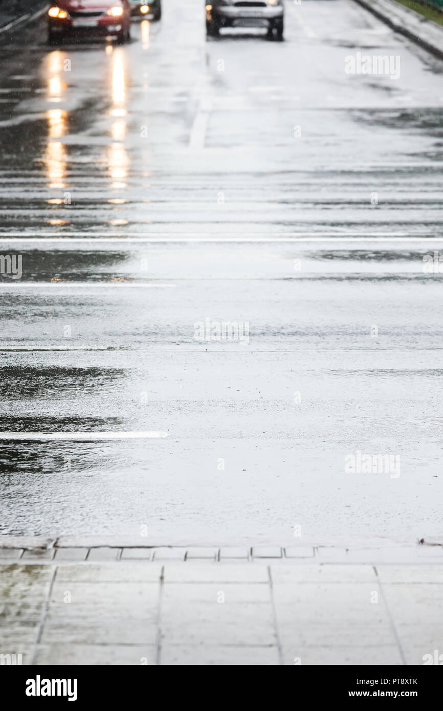 headlights of city cars reflecting in wet asphalt road surface Stock ...
