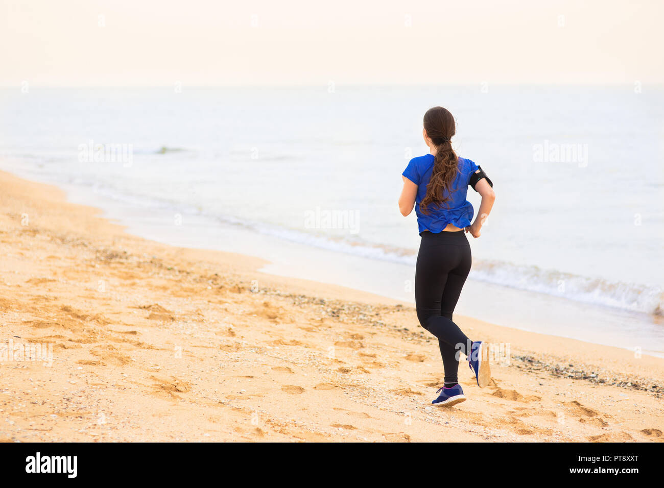 woman run on the beach Stock Photo