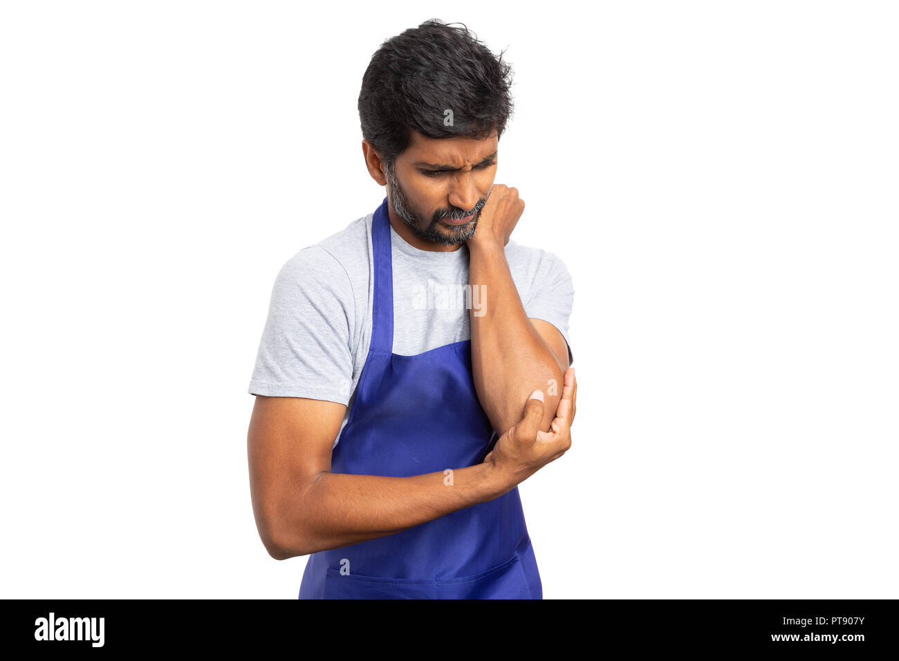 Concerned supermarket or hypermarket employee holding painful elbow with hand isolated on white background Stock Photo