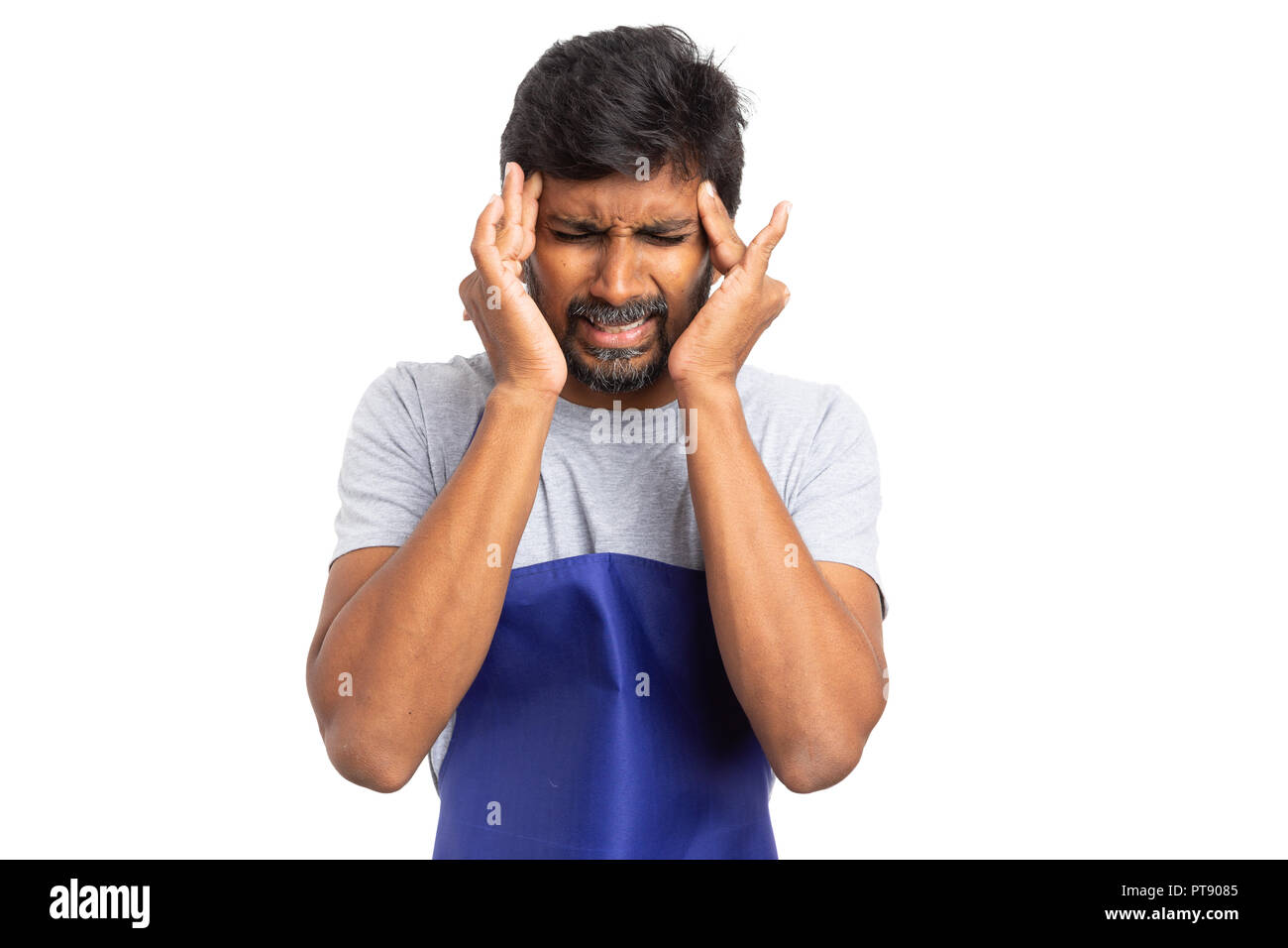 Stressed supermarket or hypermarket male employee having a migraine touching temples with both hands isolated on white background Stock Photo